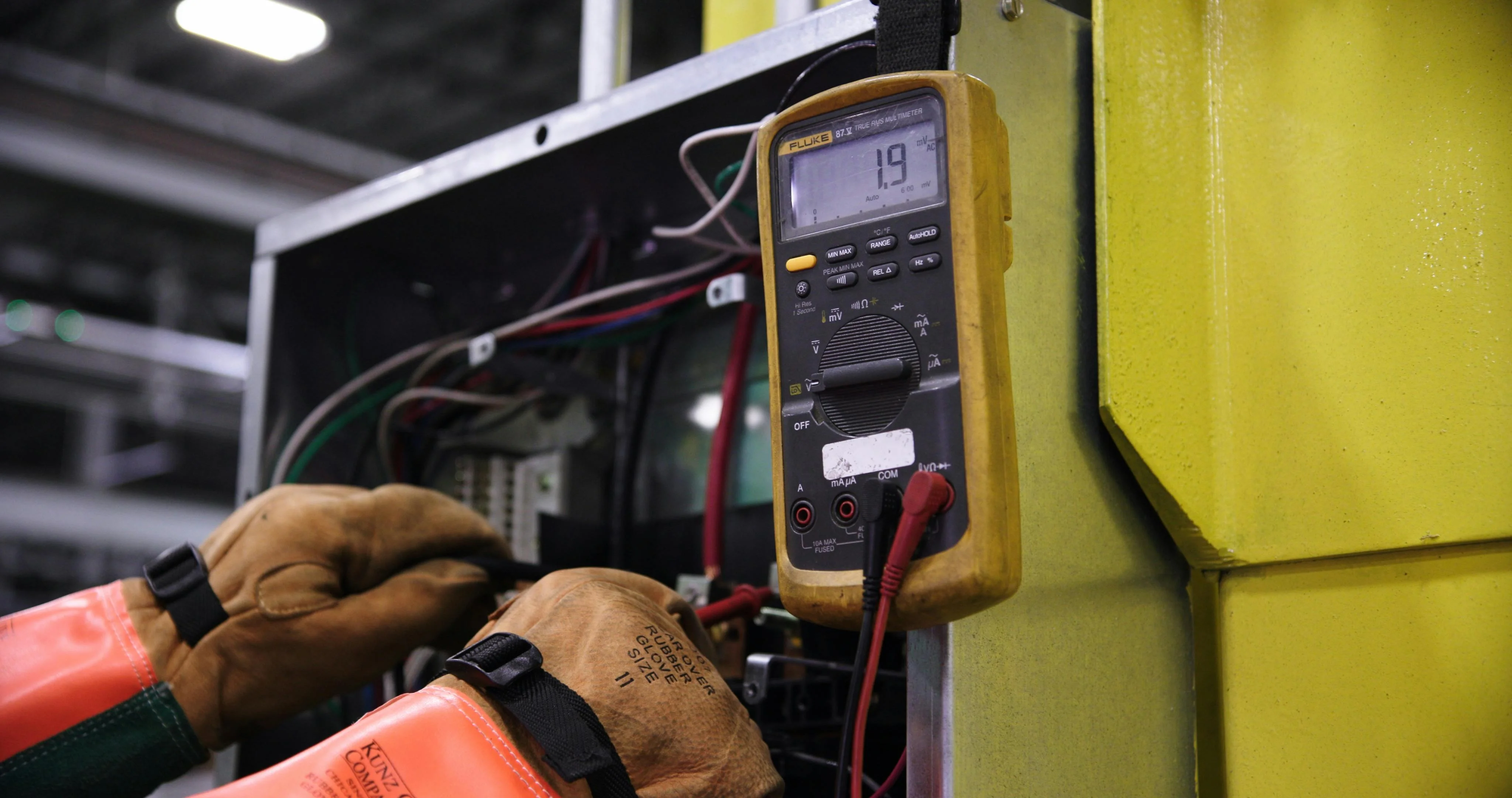 Electrician working safely on electrical panel